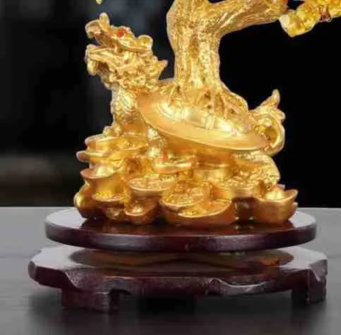 Citrine coloured resin turtle money tree Chinese style ornament on display.