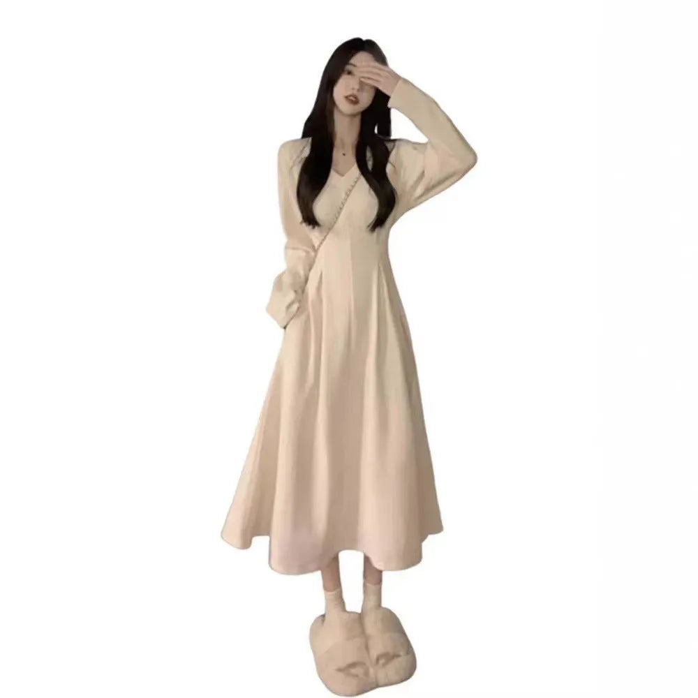 Women's long sleeveless V-neck knitted dress in milky white with a suspender skirt design.