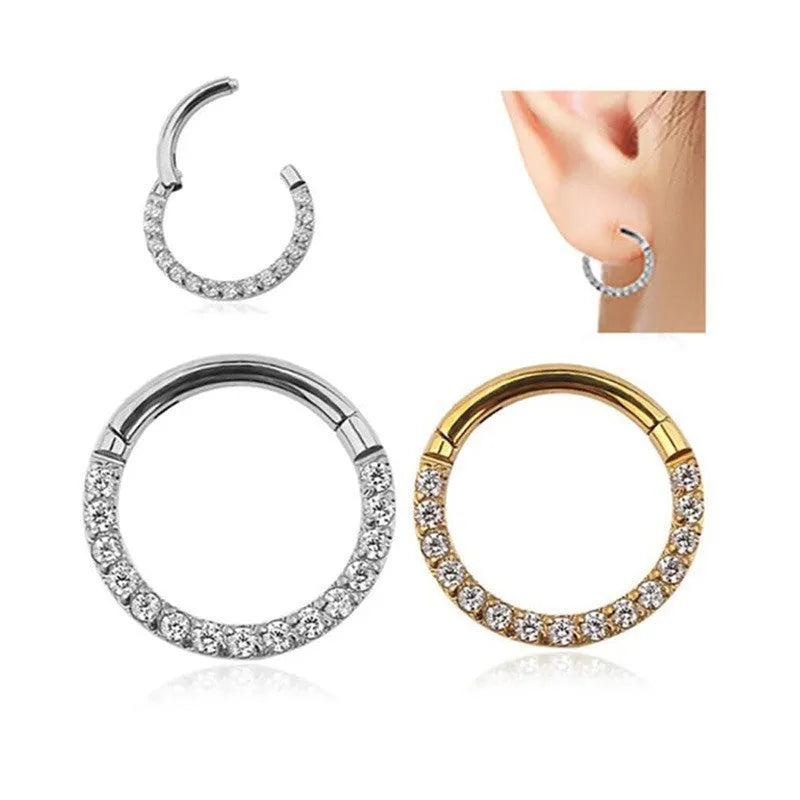 Stainless steel seamless nose ring with a small diamond on the front, shown in a gold finish.