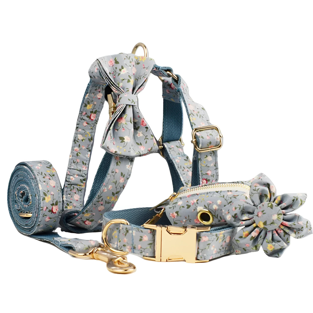 Blue floral cloth dog collar and leash set with bow and vest accessories on a size chart from XS to XL.