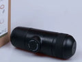 Compact black portable manual coffee machine for espresso, shown with dimensions 6cm by 17.5cm