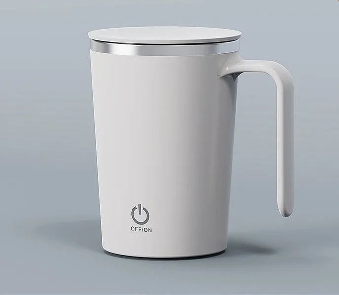 White automatic electric stirring cup with stainless steel finish and minimalist design on a table.