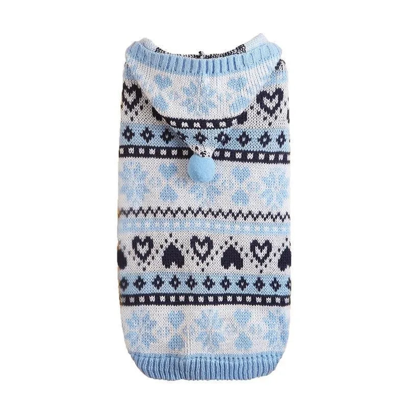 Small pink dog sweater with striped camouflage and snowflake patterns on a mannequin.