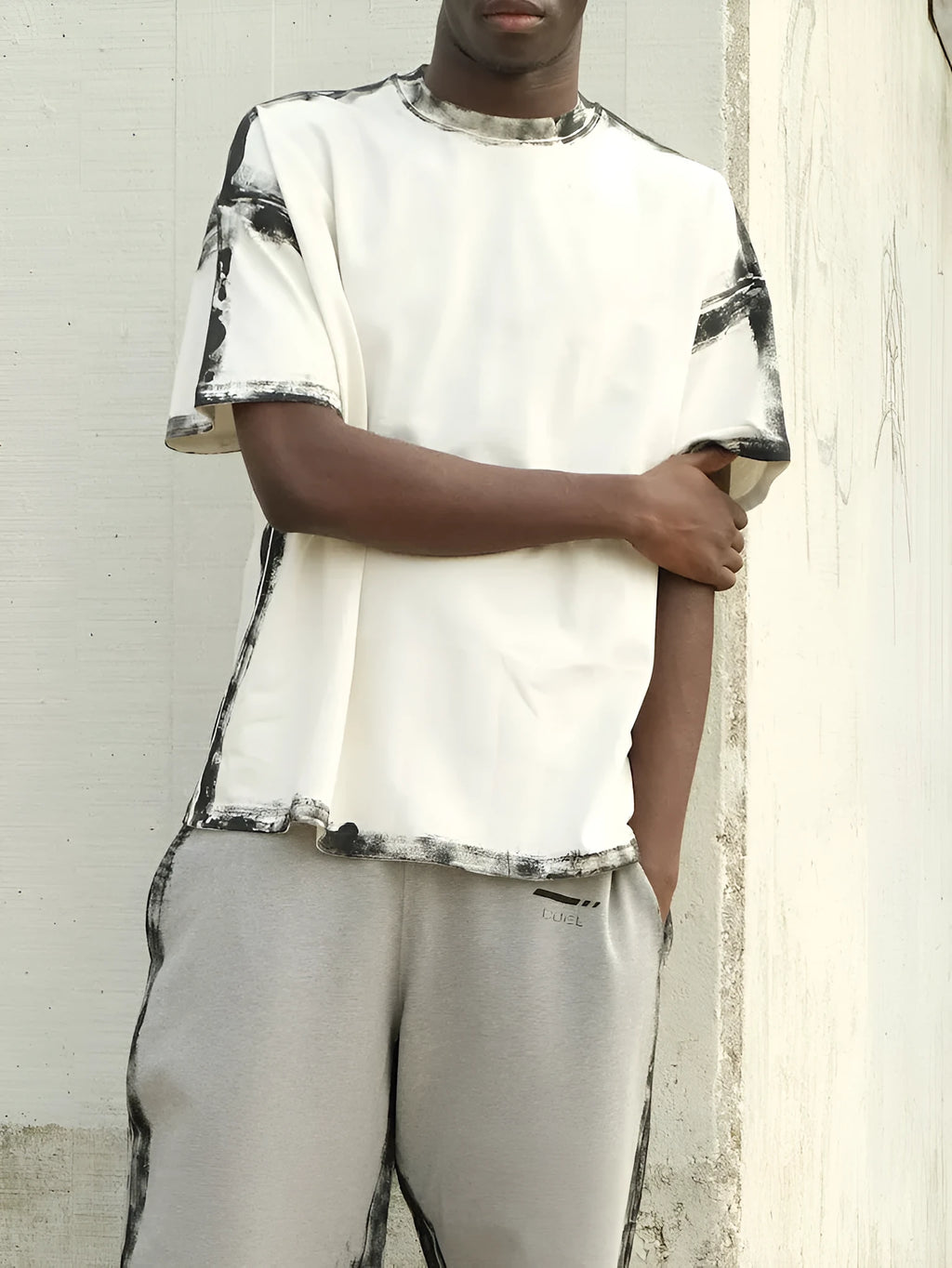 White casual short sleeve polyester top with draped design on a hanger