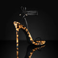 Women's leopard print Roman sandals with pointed toe and buckle fastening strap.