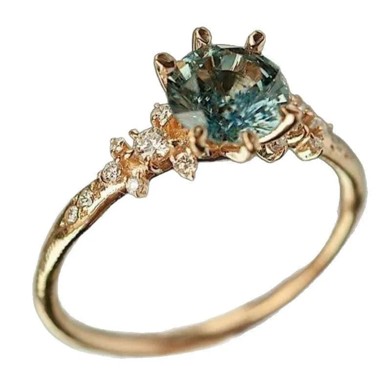 Gold-plated geometric claw ring with micro-inlaid zircon stones on a chamfered square pattern band.
