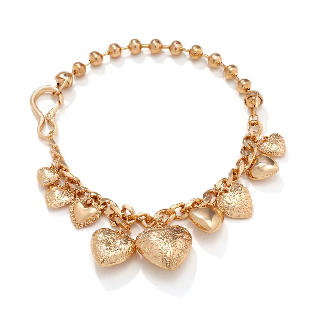 Exaggerated style gold heart pendant necklace with a regular chain on a plain background.