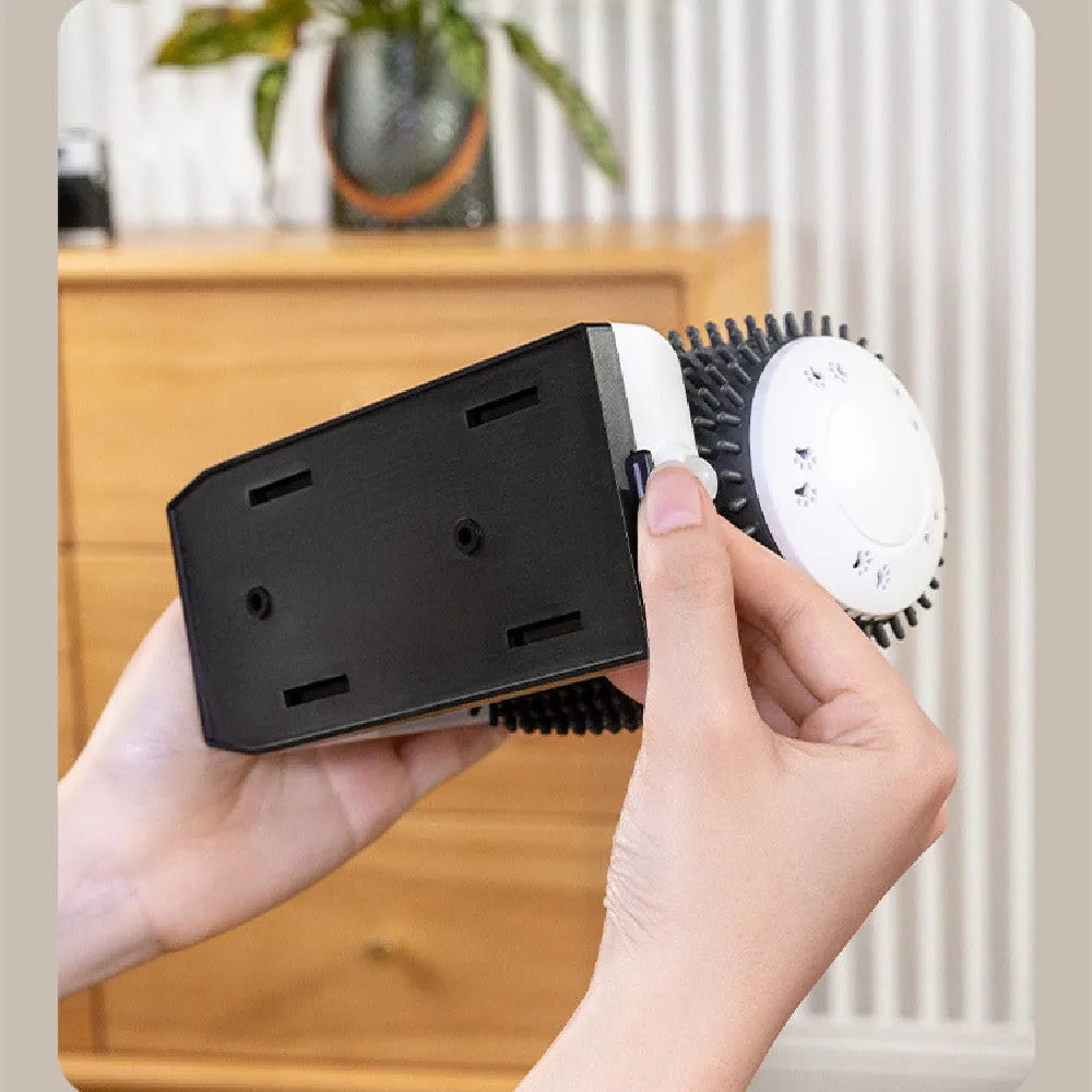 White automatic cat self-groomer brush mounted in a wall corner with soft silicone bristles.