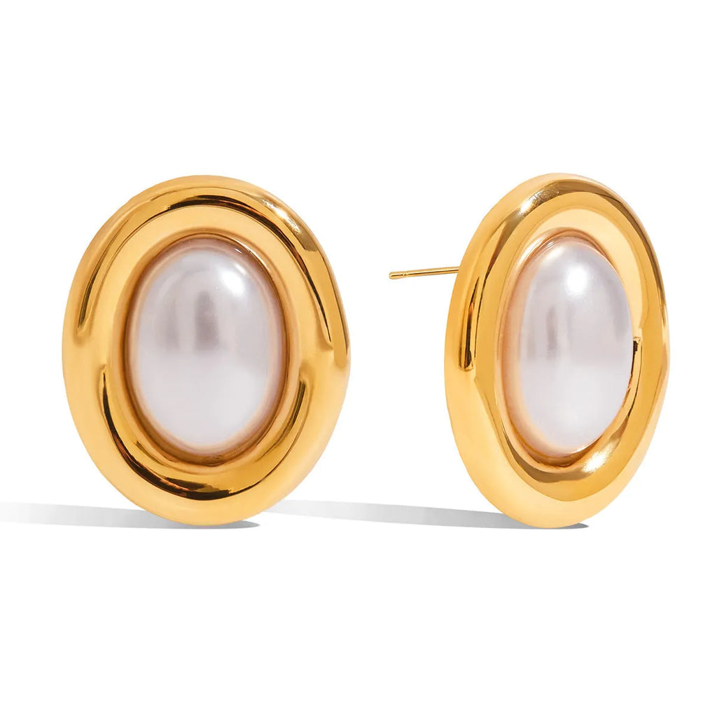 Small vintage-style pearl ear studs with a gold-tone finish on a stainless steel post.
