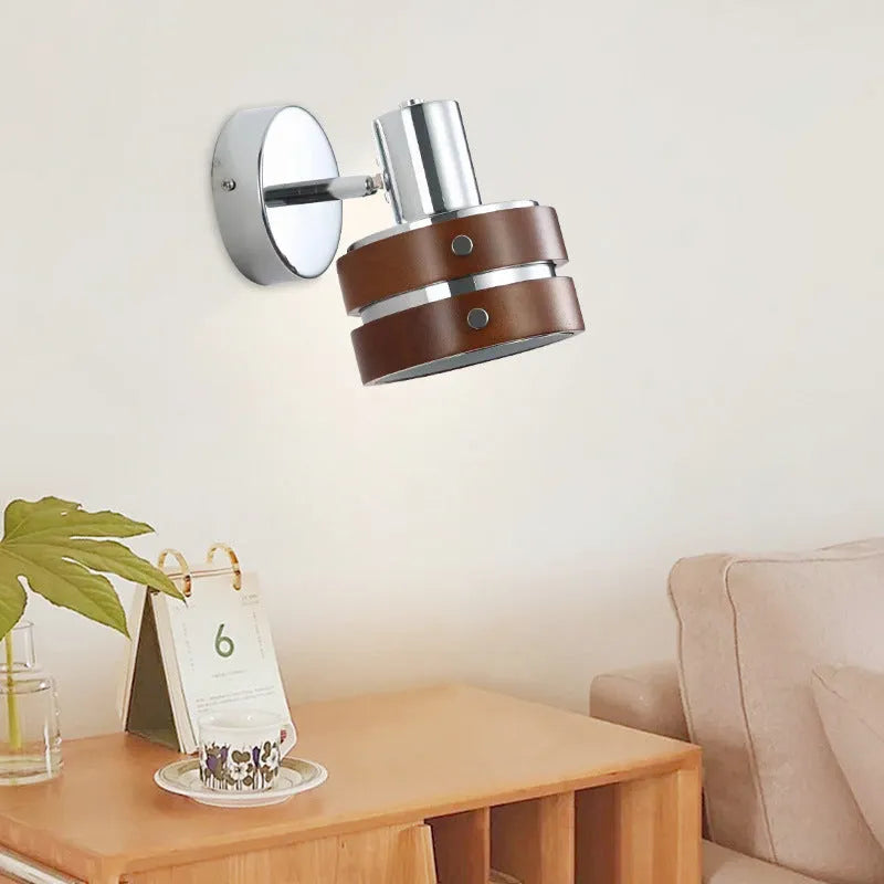 Small Scandinavian-style wall lamp with walnut wood finish, mounted on a wall.