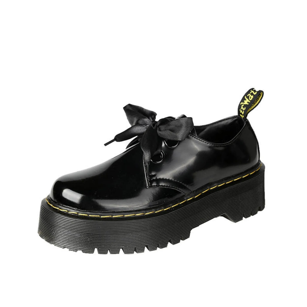 Women's black thick soled leather shoes with cross strap and ribbon lacing closure