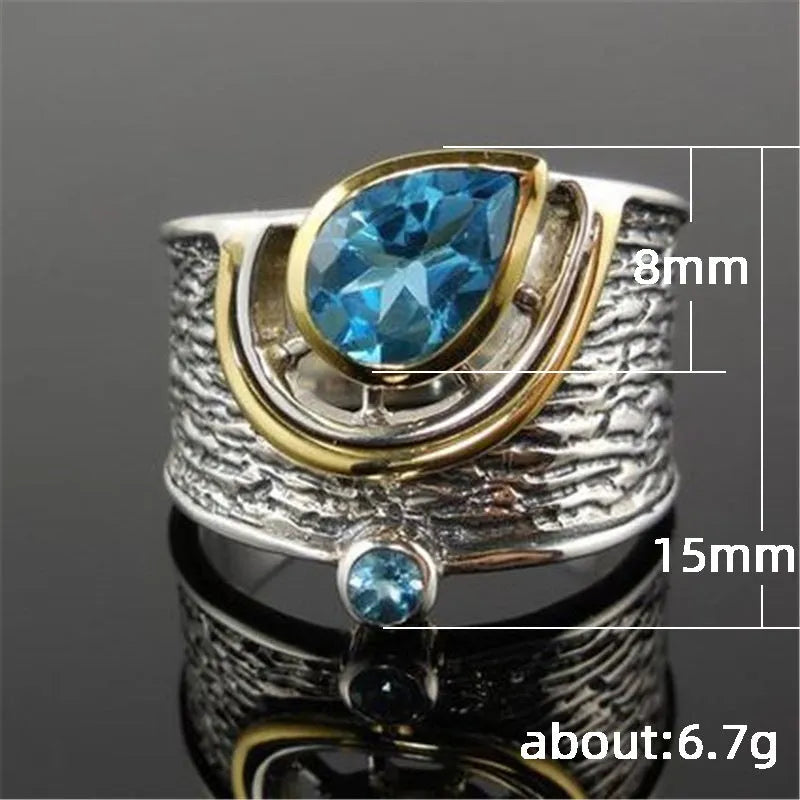 Blue zircon stone set in a drop-shaped alloy ring with Chinese style design.