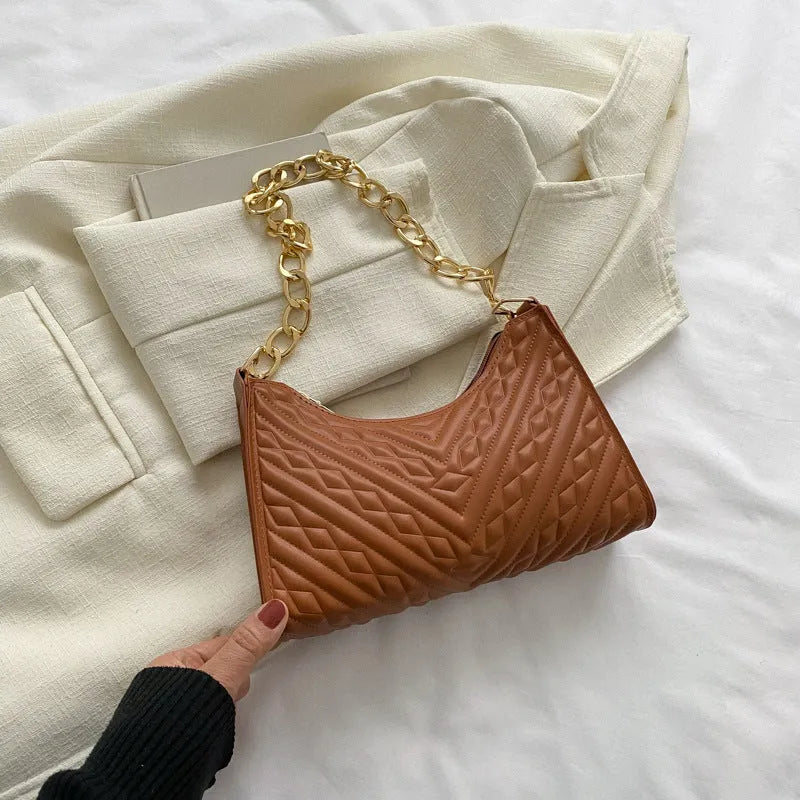 Vertical brown PU leather women's shoulder bag with a pleated front, chain strap, and soft handle.