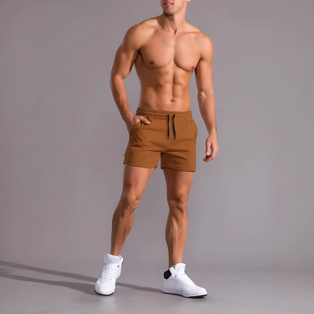 Men's solid colour drawstring shorts in black, khaki, and light brown from a 3-pack, loose fit.