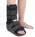 Black Achilles tendon rehabilitation boot with aluminium uprights on a grey background.