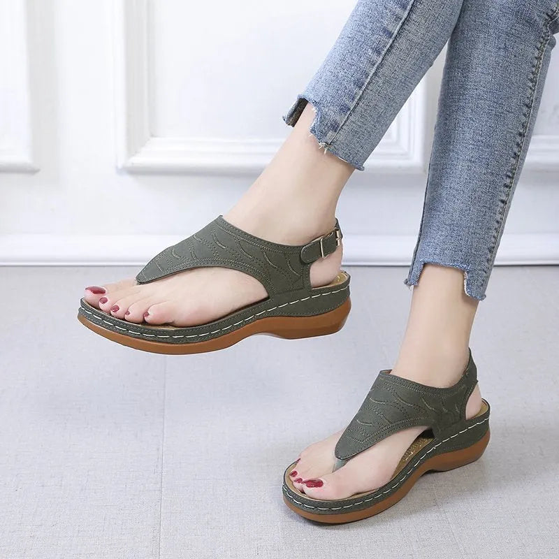 Women's black casual wedge heel sandals with an adjustable buckle strap on ankle.