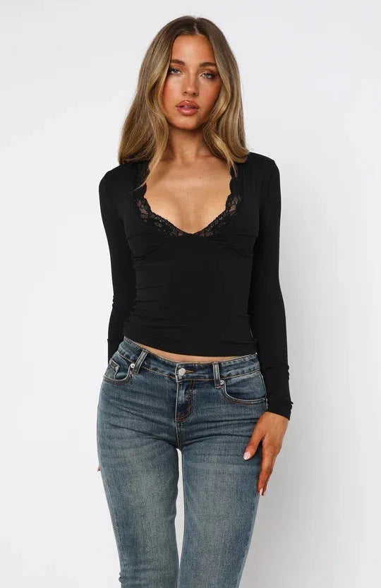 Black slim-fit women's long sleeve top with floral lace detailing on the front.
