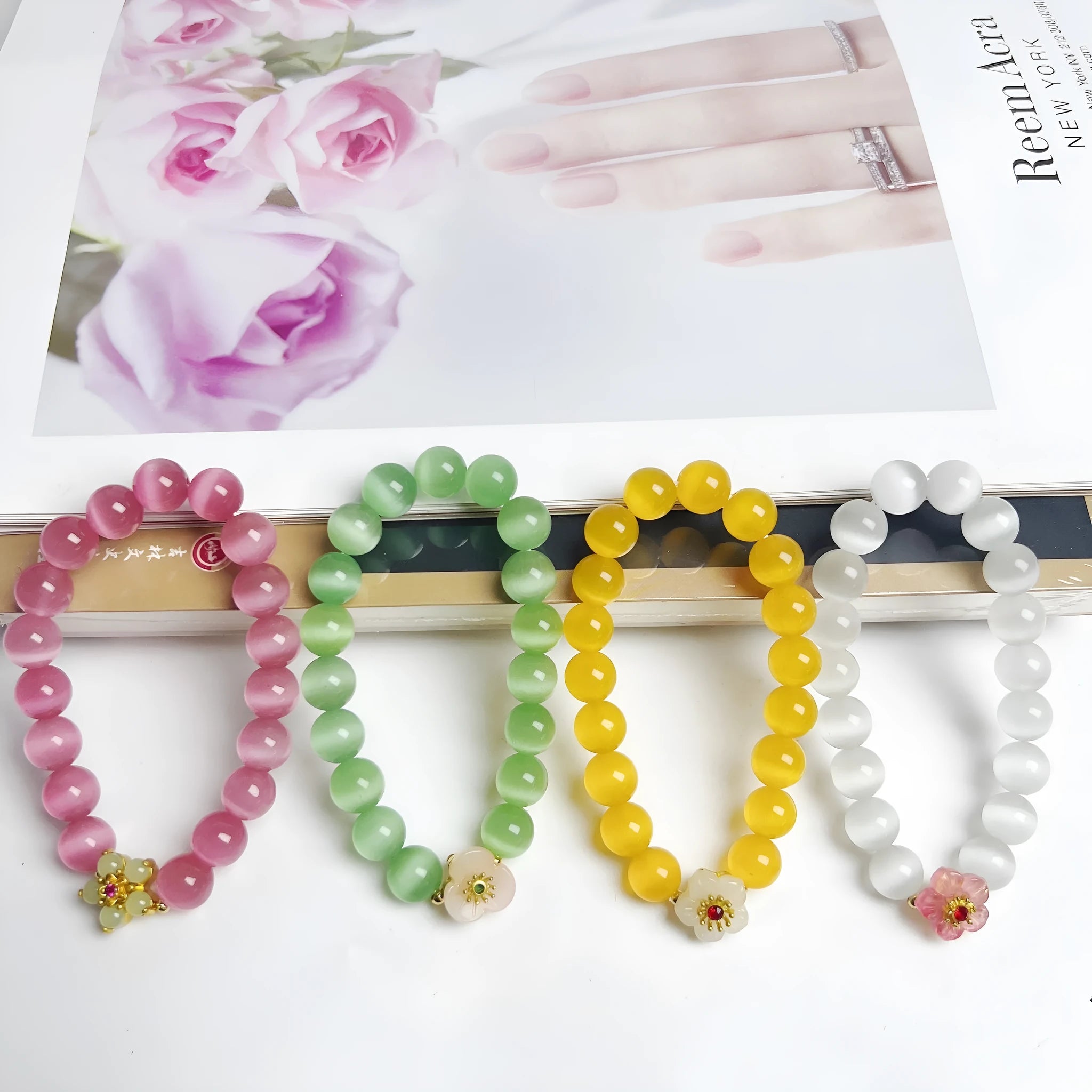 Handmade women's glass beaded bracelet with floral elements in yellow, pink, white, or green options