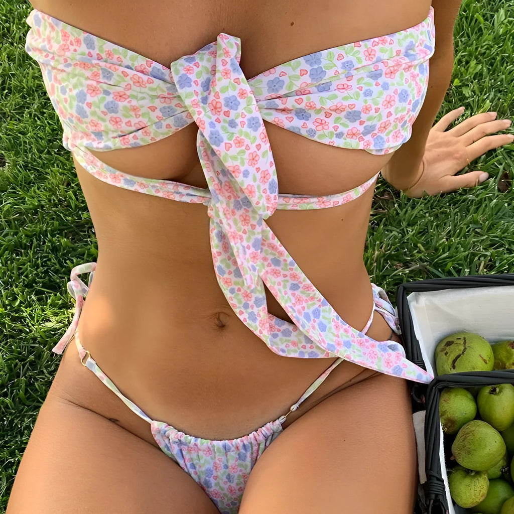 Women's wireless swimsuit with lace-up front and built-in chest pads in a floral print.