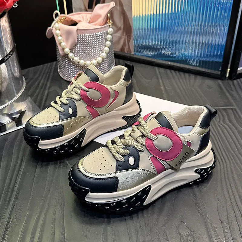 A pair of thick-soled leather sports casual shoes with a wedge heel and round toe in a lace-up design.