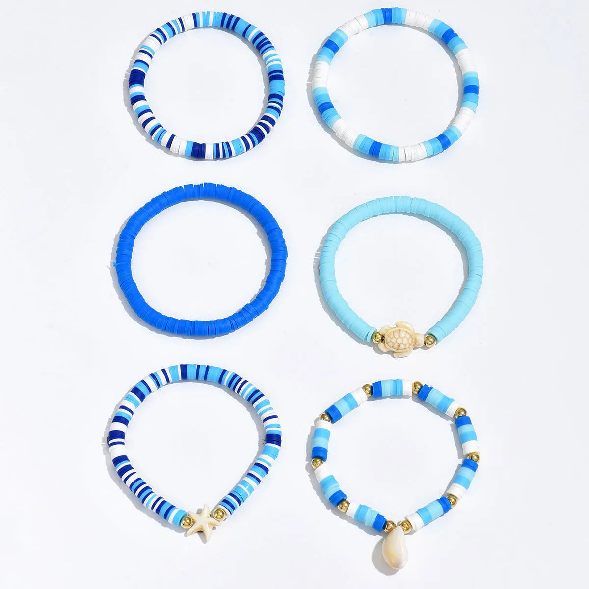 Six Bohemian blue polymer clay bracelets with geometric shell designs arranged as a set