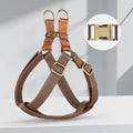 Brown vest-style dog leash harness on small dog showing chest design and alloy fastener