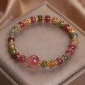 Handmade tourmaline strawberry quartz bracelet with 10mm round lucky beads for gifting occasions