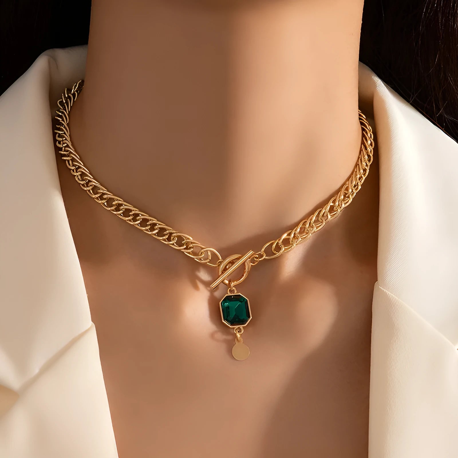 Gold French retro necklace with round geometric pendant featuring emerald zircon stone on Cuban link chain