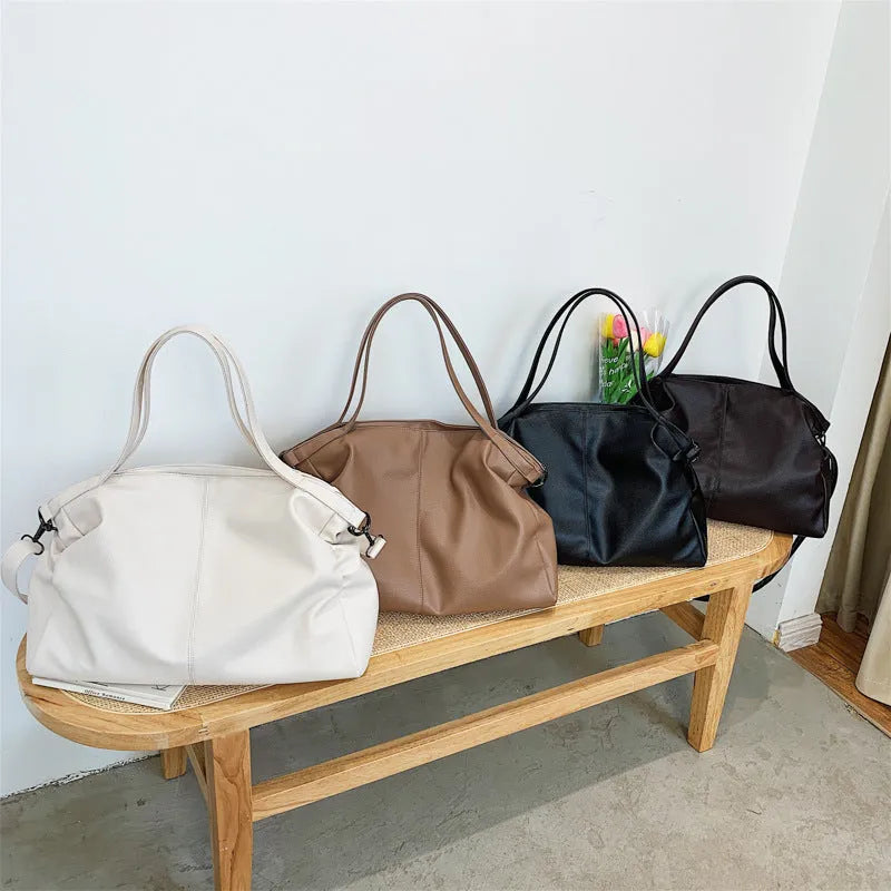 Large khaki soft PU messenger bag with long strap, shown open with internal phone and zipper pockets.