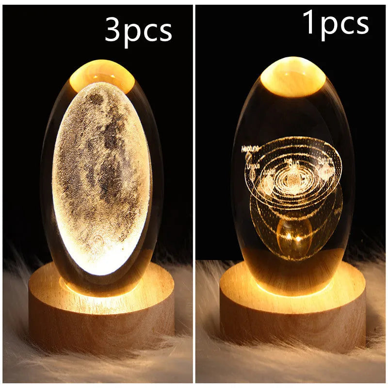 LED galaxy crystal ball night light with 3D planet designs on a table