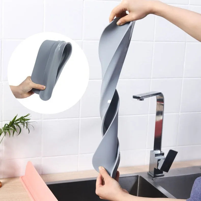 A grey silicone sink water blocking plate measuring 52mm by 85mm.