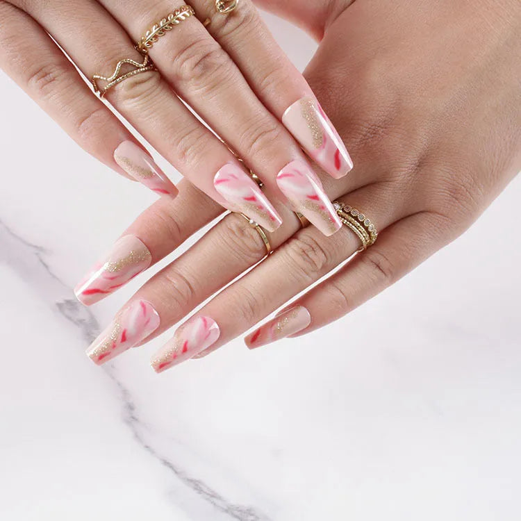 Wearable manicure set showing 24 artificial nails with rose, tulip, leopard and XINGX designs