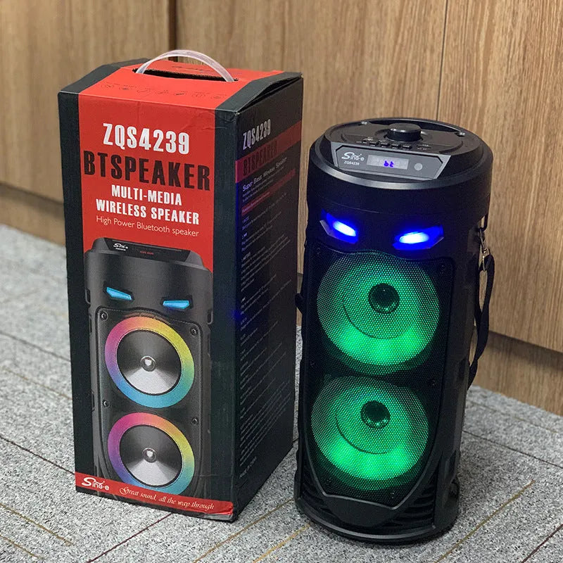 Black portable Bluetooth speaker with dual horn design and wheat detailing, showing USB port and card slot