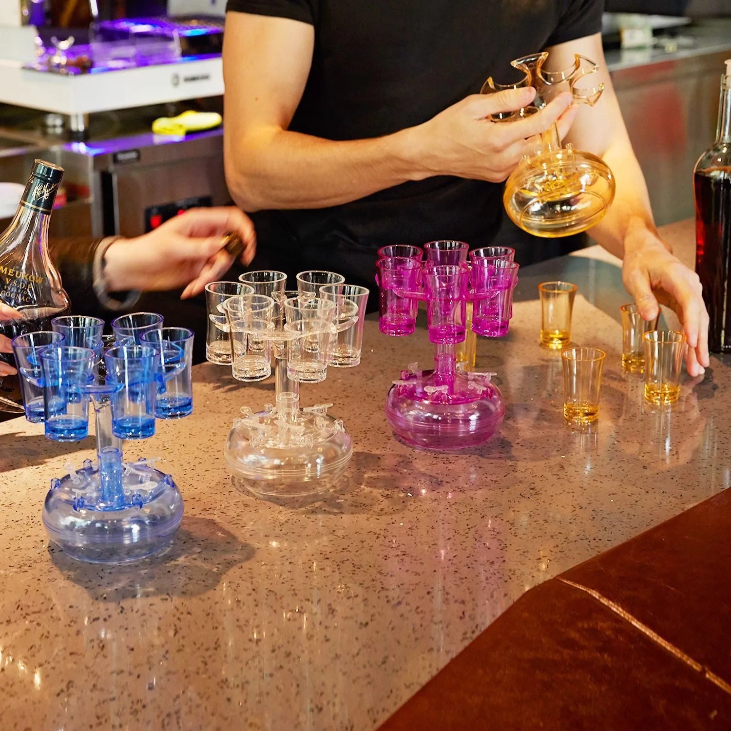 Transparent Plexiglass 6-shot glass dispenser rack holding six cups on a stand.