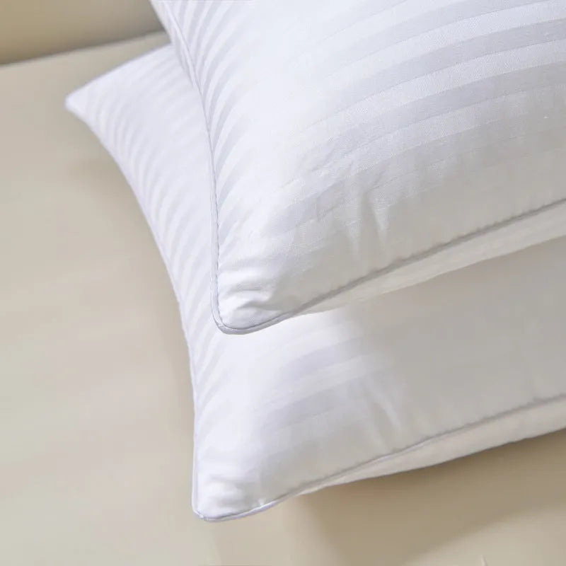 White cotton satin stripe feather pillow showing simple design and hotel-style aesthetic
