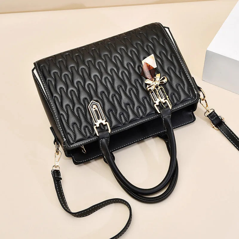 Women's large black PU shoulder messenger bag with front pocket and shoulder strap.
