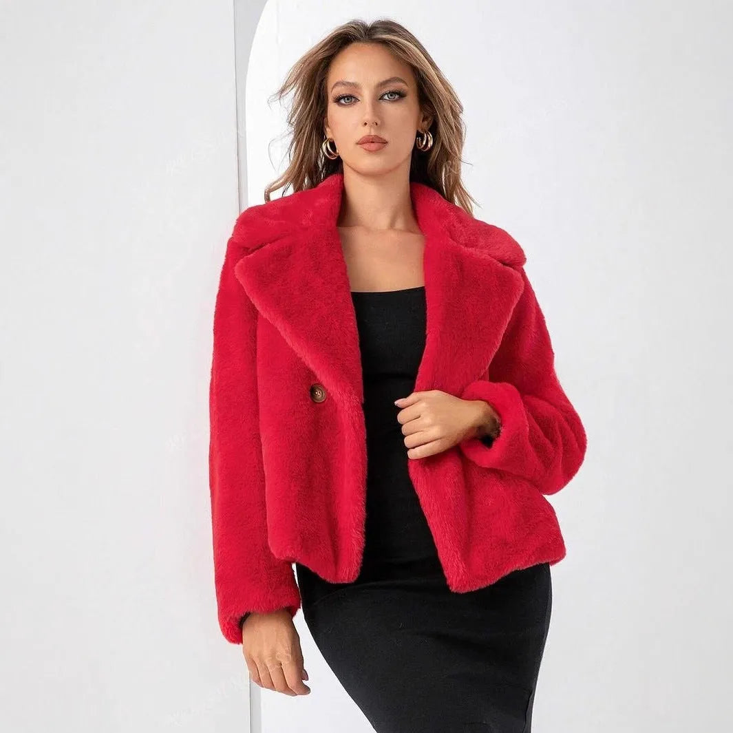 Women's loose short faux fur coat in rose red on a hanger, showing regular sleeves and textured fabric.